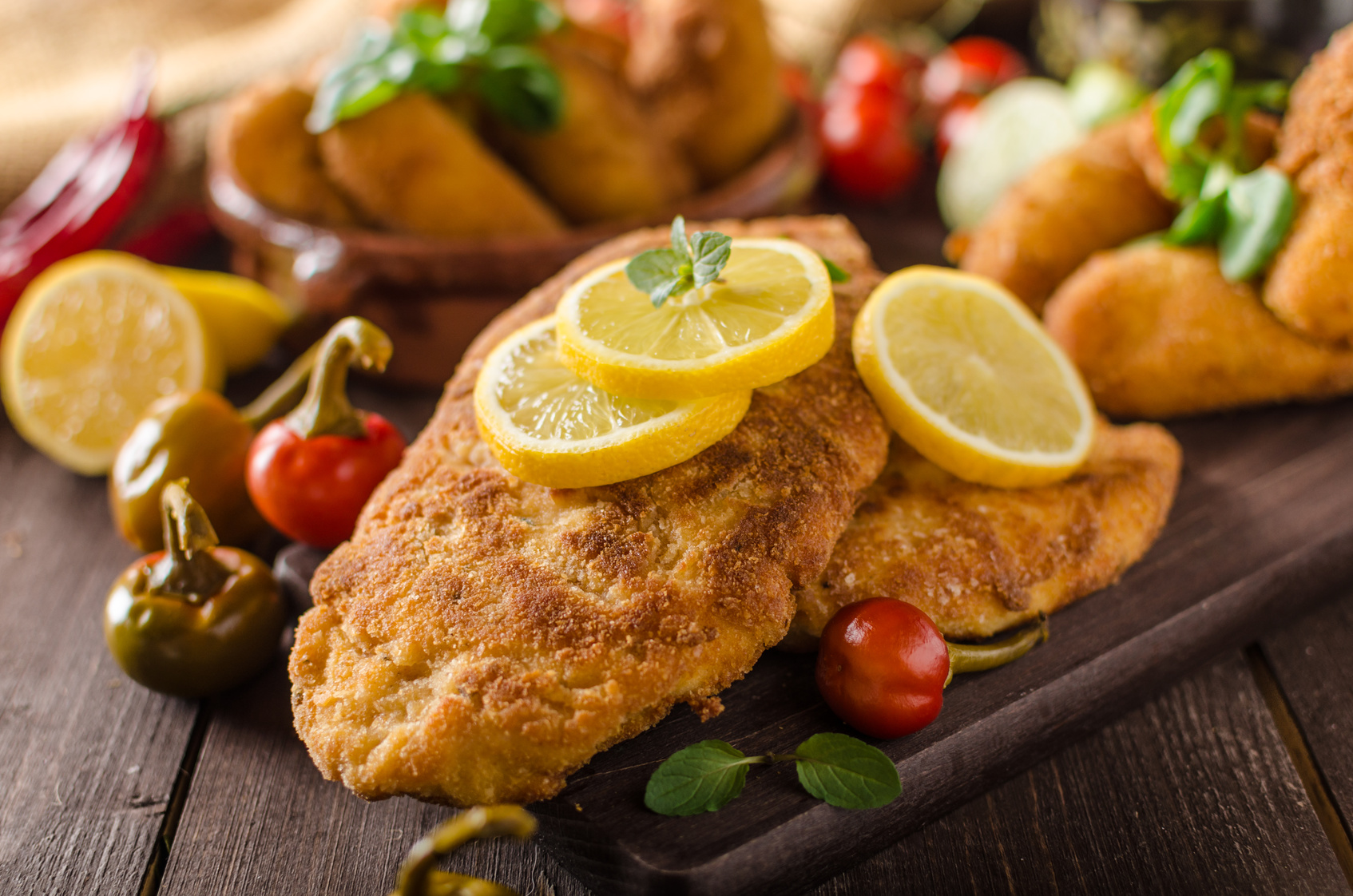 Chicken schnitzel and homemade potato croquettes with cheese and chilli